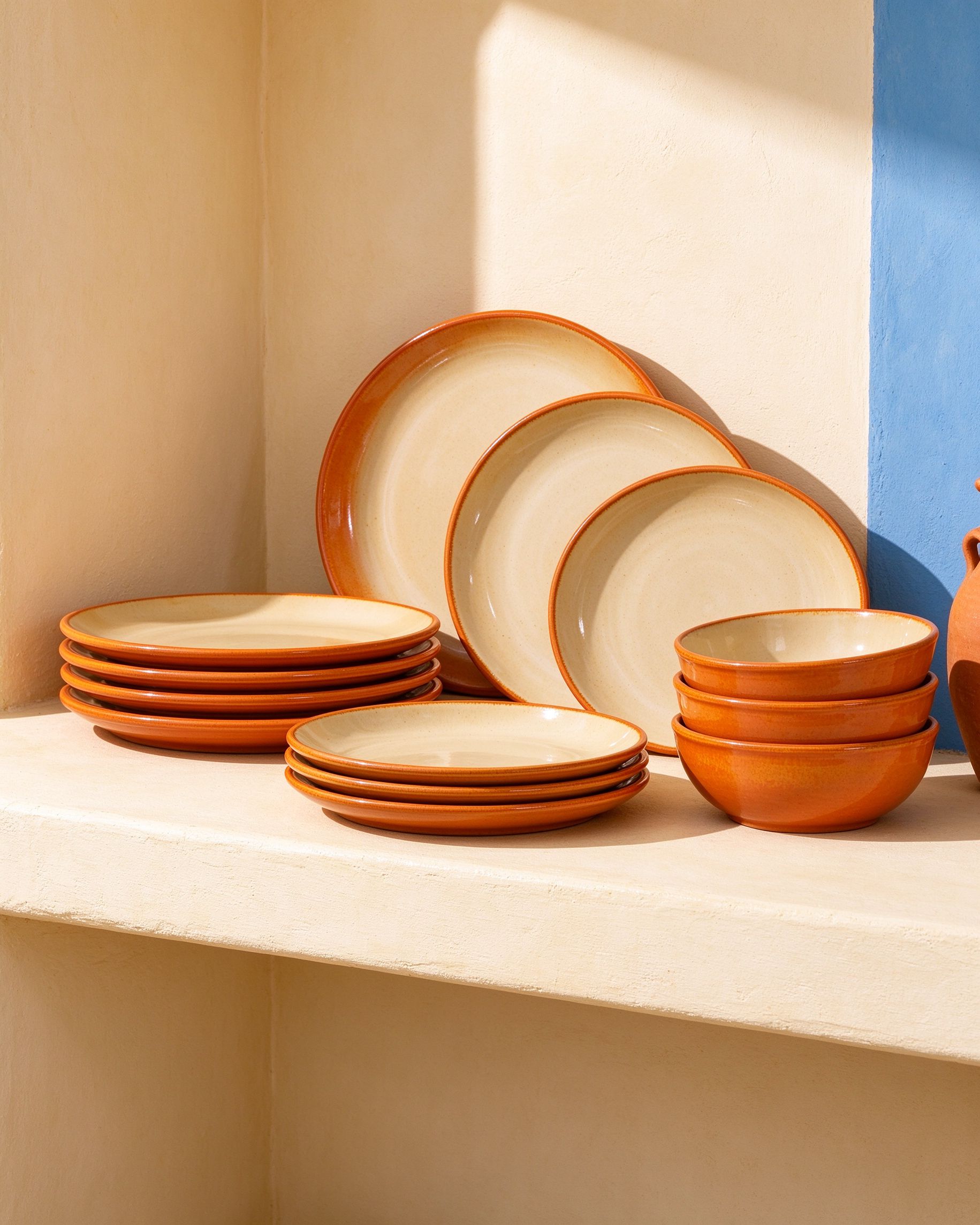 Terracotta ceramic dinnerware set with cream interiors